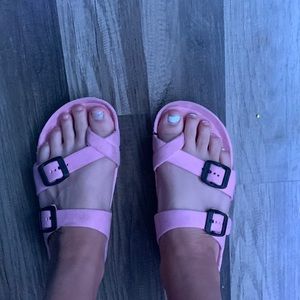 Pink sandals they are tarred at the toe of the right shoe